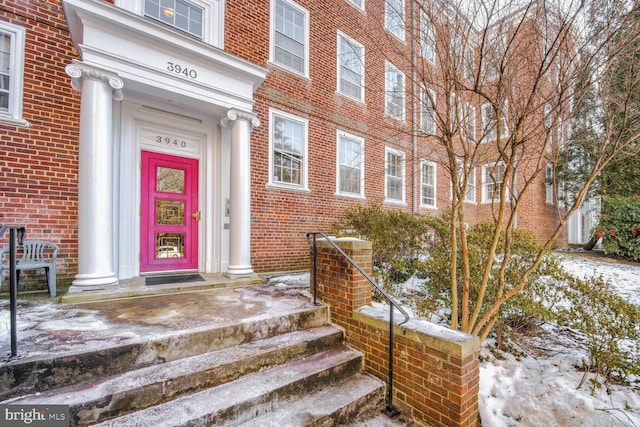 view of snow covered property entrance