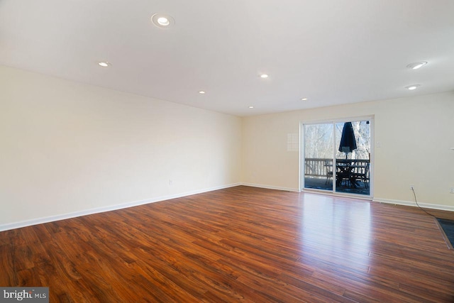 unfurnished living room with dark wood-type flooring