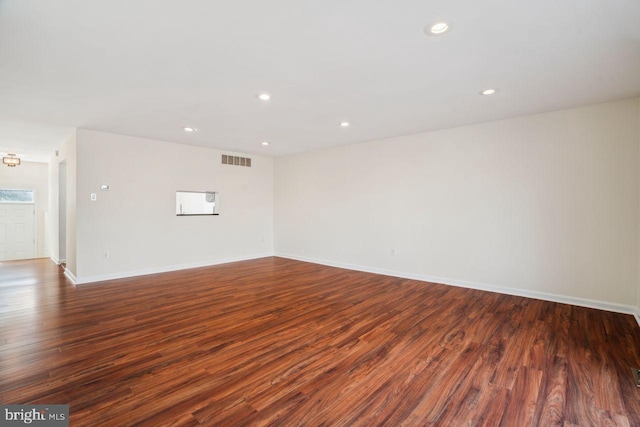 spare room with dark hardwood / wood-style flooring