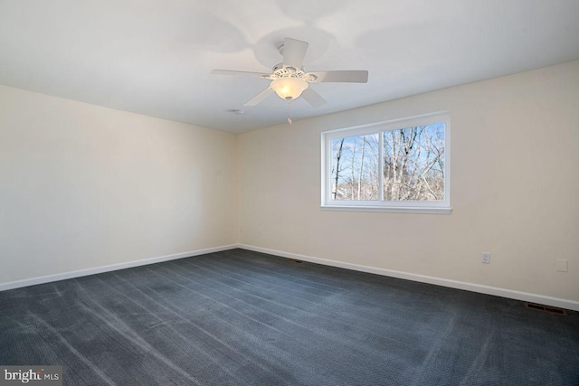 carpeted empty room featuring ceiling fan