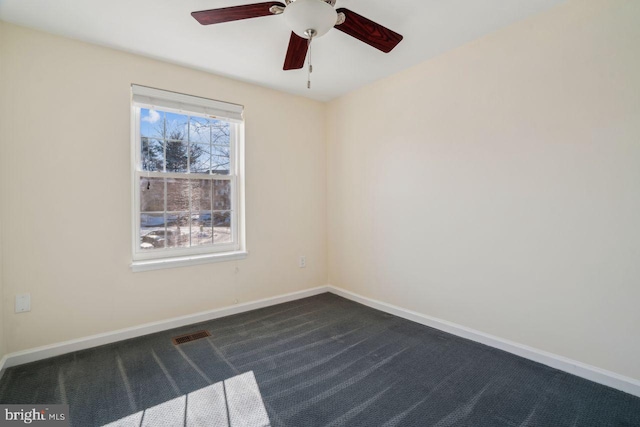 unfurnished room with ceiling fan and dark carpet