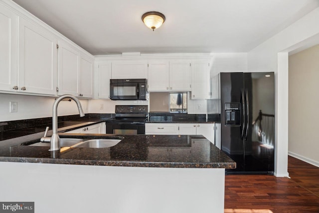 kitchen featuring white cabinets, dark stone countertops, kitchen peninsula, and black appliances