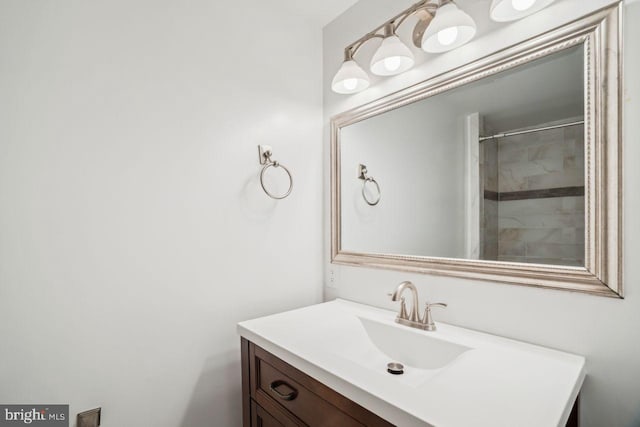 bathroom with vanity and a tile shower