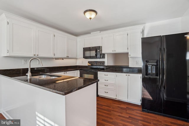 kitchen featuring sink, black appliances, kitchen peninsula, dark stone counters, and white cabinets