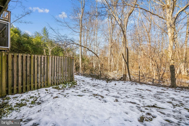 view of yard layered in snow