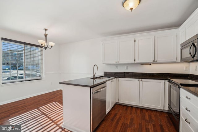 kitchen with sink, white cabinetry, hanging light fixtures, kitchen peninsula, and black appliances