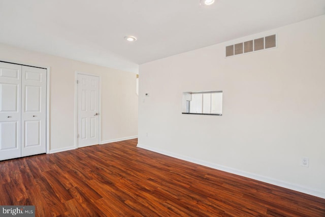 unfurnished bedroom featuring dark hardwood / wood-style flooring