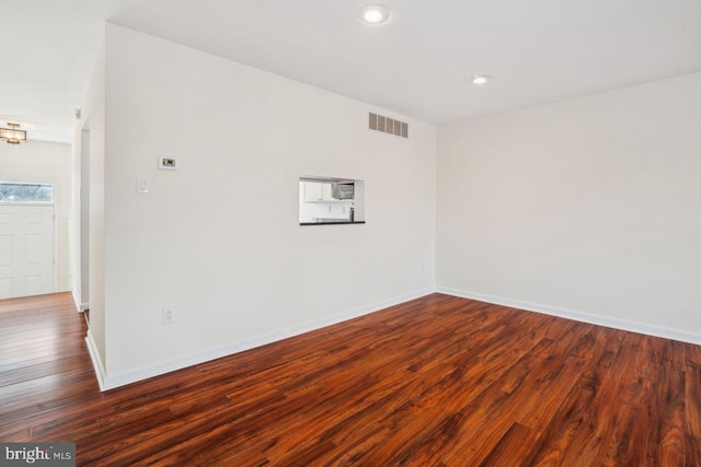 empty room featuring dark wood-type flooring