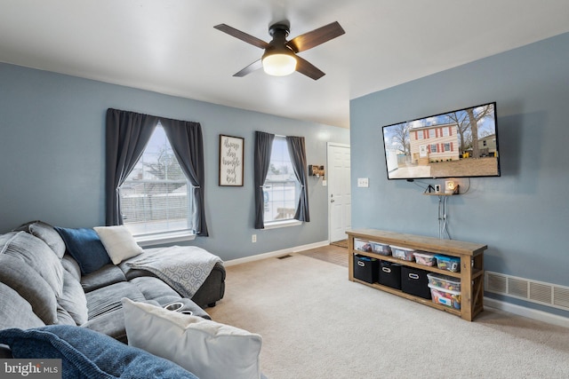 living room featuring carpet flooring and ceiling fan