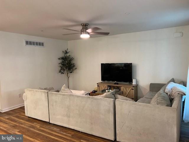 living room featuring ceiling fan and dark hardwood / wood-style floors