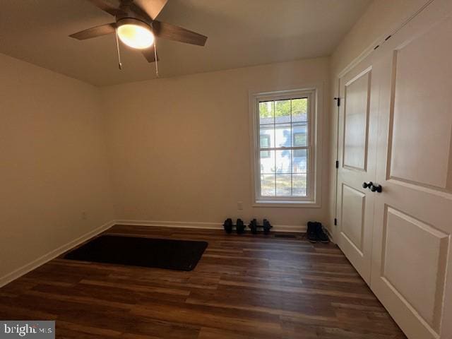 unfurnished room featuring ceiling fan and dark wood-type flooring