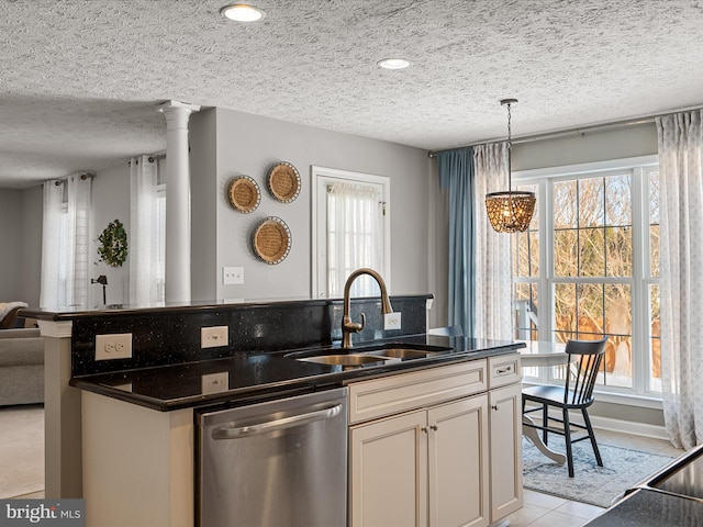 kitchen with sink, a textured ceiling, dishwasher, and a wealth of natural light