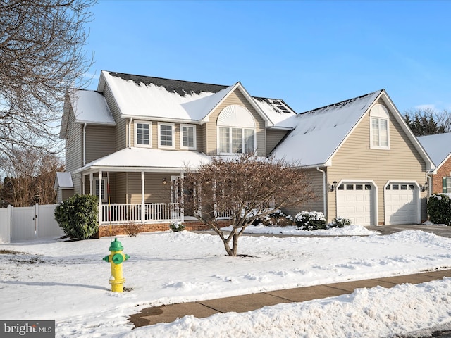 view of front facade with a garage and covered porch