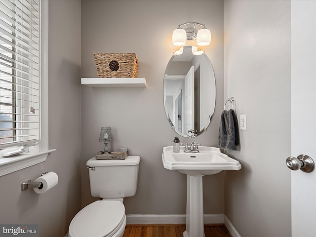 bathroom featuring hardwood / wood-style floors and toilet