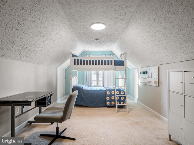 office space featuring vaulted ceiling, light colored carpet, and a textured ceiling