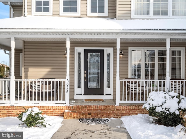 view of snow covered property entrance