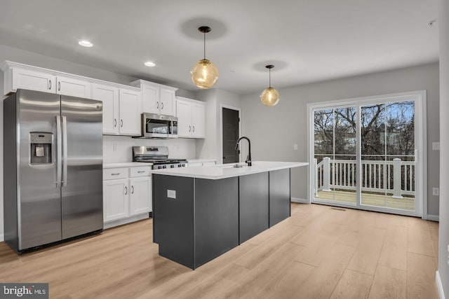 kitchen with white cabinetry, hanging light fixtures, and appliances with stainless steel finishes