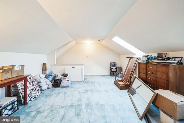 bonus room with light carpet and vaulted ceiling with skylight