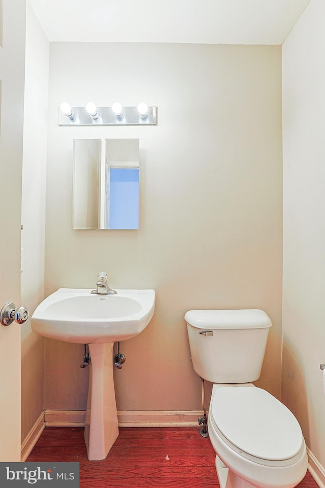 bathroom featuring wood-type flooring and toilet