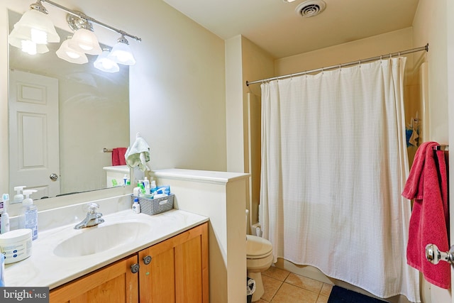 full bathroom featuring shower / bath combo with shower curtain, tile patterned floors, toilet, and vanity