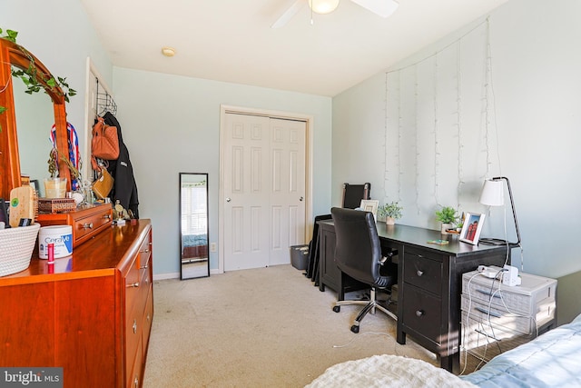 office space featuring ceiling fan and light colored carpet