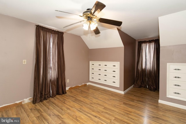 additional living space featuring lofted ceiling, light hardwood / wood-style floors, and ceiling fan