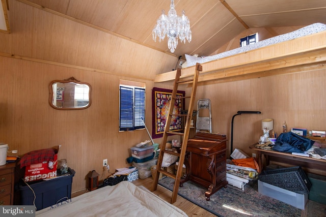 bedroom featuring hardwood / wood-style flooring, wooden walls, wooden ceiling, and an inviting chandelier