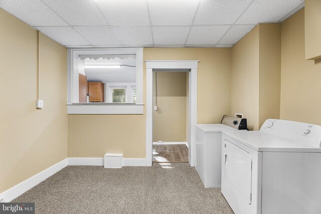 laundry room featuring light carpet and washing machine and dryer