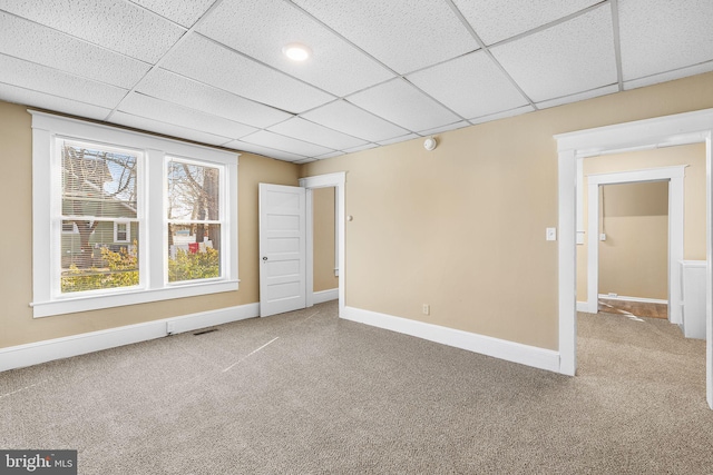 interior space featuring carpet floors and a paneled ceiling