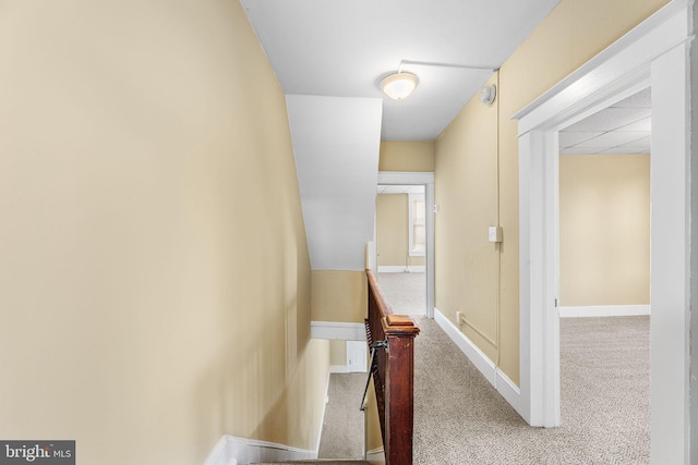 hall featuring light colored carpet