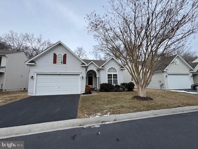 view of front of home with a garage and a front yard