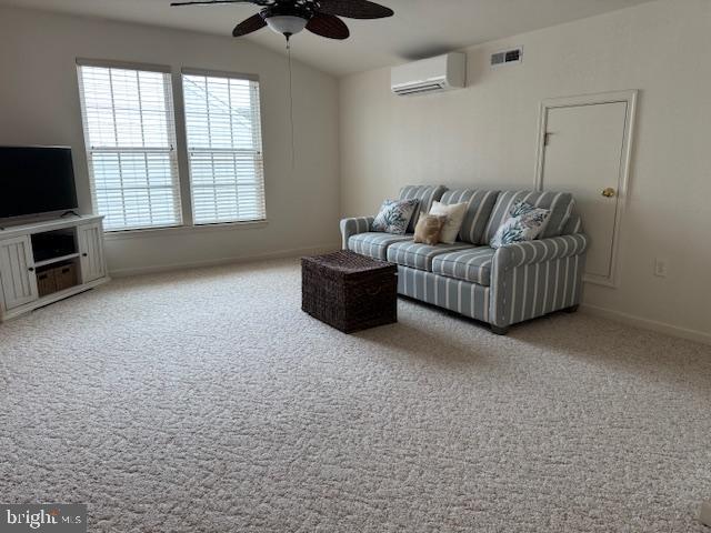 living room with an AC wall unit, plenty of natural light, ceiling fan, and carpet flooring