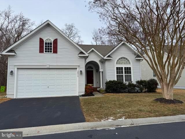 view of front of property with a garage and a front yard