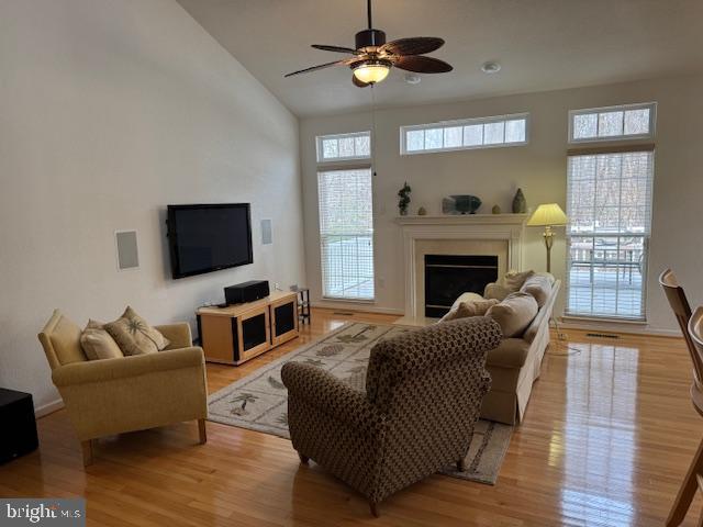 living room featuring ceiling fan and light hardwood / wood-style flooring