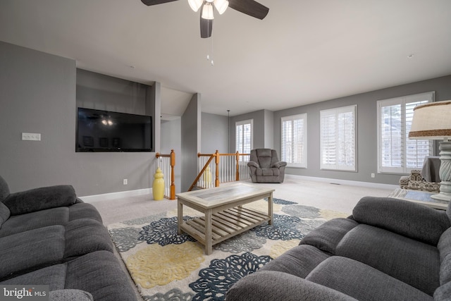 carpeted living room with plenty of natural light and ceiling fan