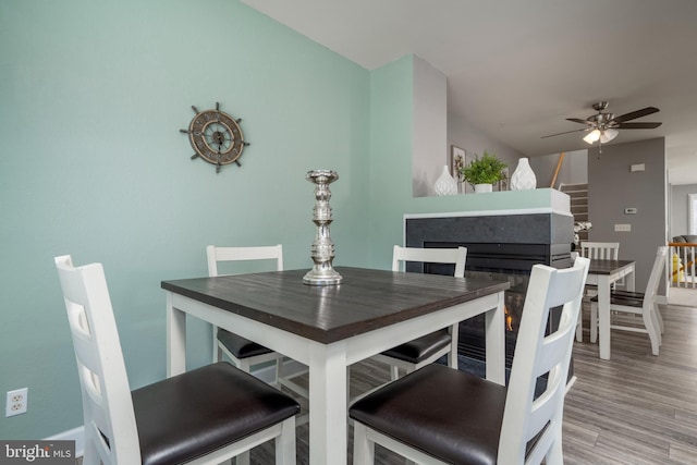 dining space featuring ceiling fan and light wood-type flooring