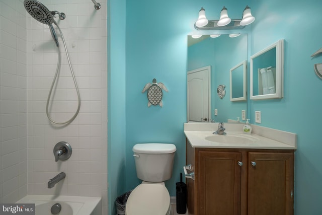 full bathroom with tiled shower / bath combo, vanity, and toilet