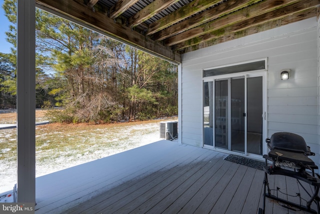 wooden deck with a grill and central air condition unit