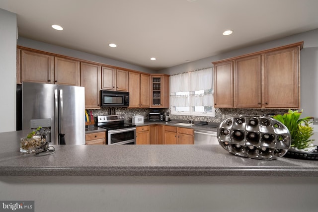 kitchen featuring tasteful backsplash, stainless steel appliances, and sink