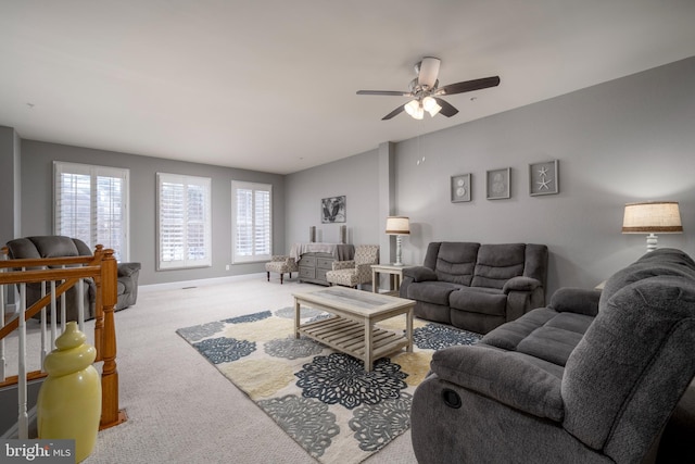 carpeted living room with ceiling fan