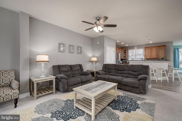 carpeted living room featuring ceiling fan