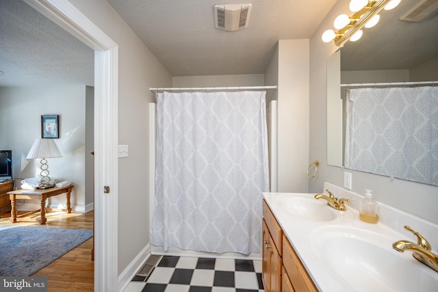 bathroom with vanity and a textured ceiling