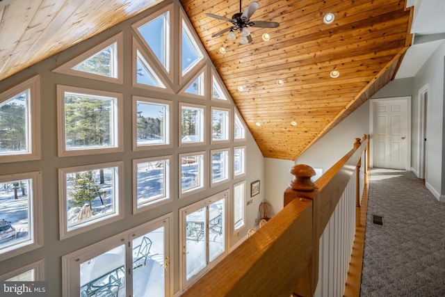 hall featuring wood ceiling, vaulted ceiling, and carpet