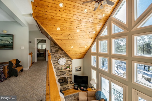 hallway featuring wood ceiling, a wealth of natural light, and high vaulted ceiling