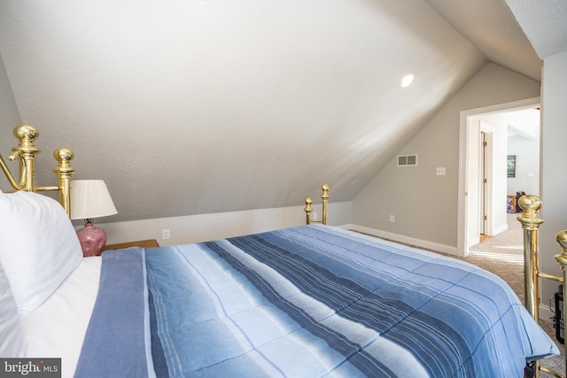 carpeted bedroom with vaulted ceiling