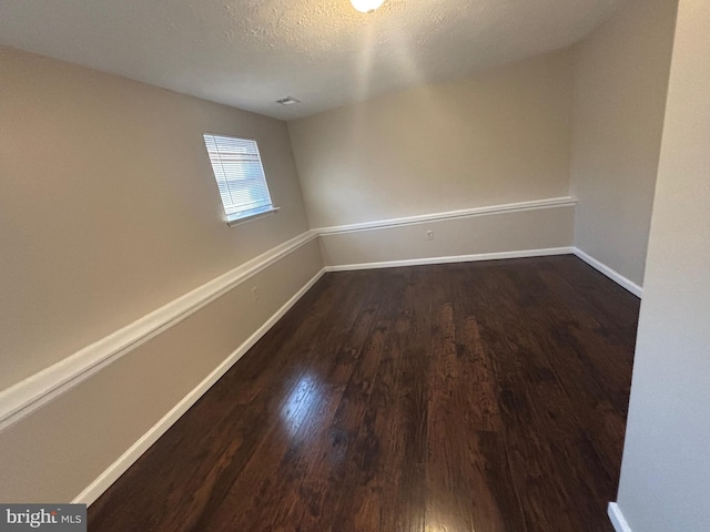 12725 Bar Oak Dr, Waldorf, MD 20601 - unfurnished room featuring dark wood-type flooring and a textured ceiling