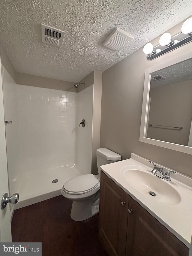 12725 Bar Oak Dr, Waldorf, MD 20601 - bathroom with vanity, a textured ceiling, toilet, and a shower