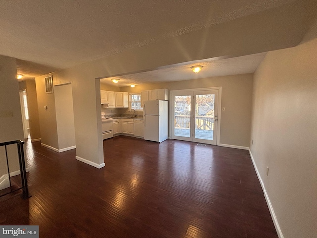 12725 Bar Oak Dr, Waldorf, MD 20601 - unfurnished living room with dark wood-type flooring and a textured ceiling