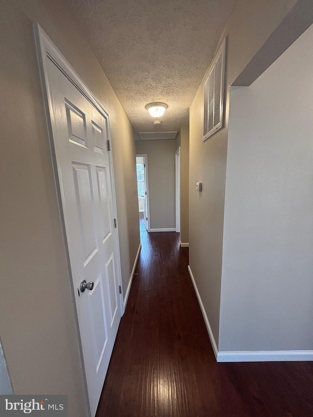 12725 Bar Oak Dr, Waldorf, MD 20601 - hallway with dark hardwood / wood-style flooring and a textured ceiling