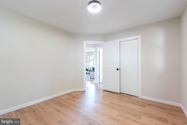 unfurnished room with light wood-type flooring